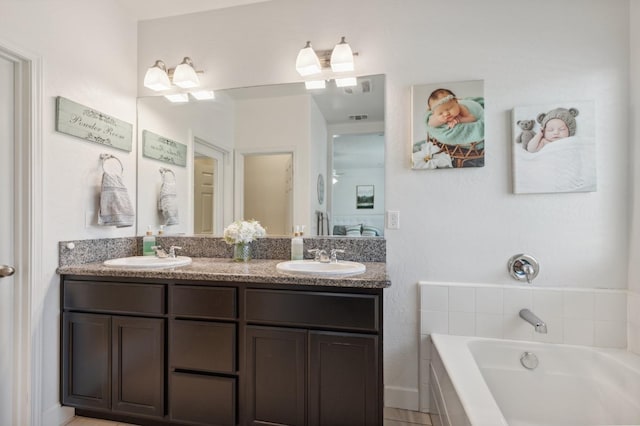 3821 Leigh Ln, Clovis, CA 93619 - full bathroom featuring a garden tub, visible vents, a sink, and double vanity