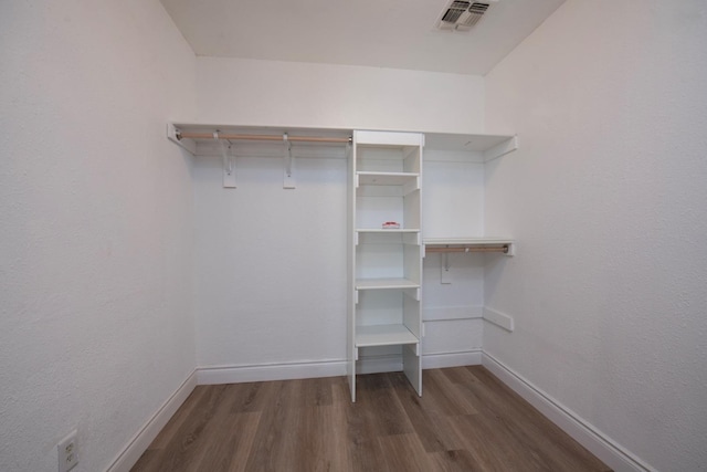 walk in closet featuring dark wood-style flooring and visible vents