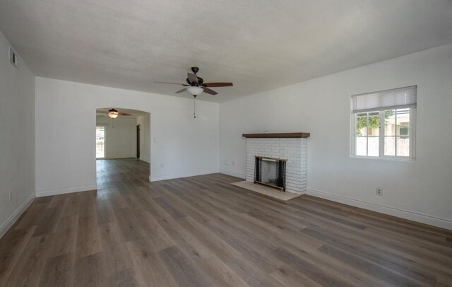 935 E Fedora Ave, Fresno, CA 93704 - unfurnished living room featuring ceiling fan, plenty of natural light, a fireplace, and wood finished floors