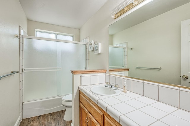 42153 Hemlock Ln, Shaver Lake, CA 93664 - bathroom featuring wood finished floors, toilet, vanity, and shower / bath combination with glass door