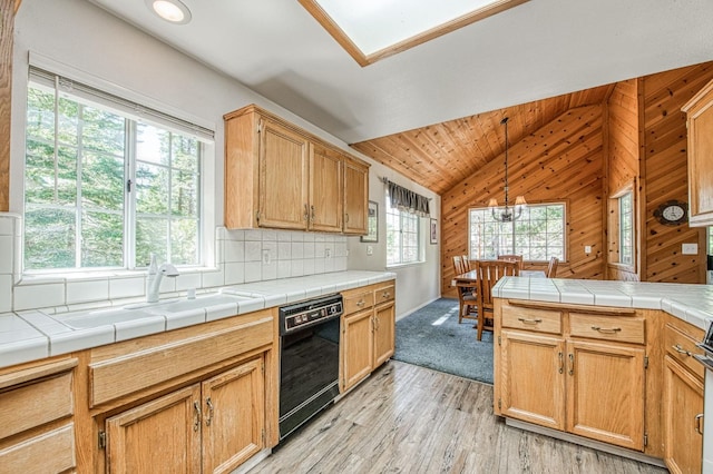 42153 Hemlock Ln, Shaver Lake, CA 93664 - kitchen featuring black dishwasher, lofted ceiling, light wood-style flooring, a sink, and tasteful backsplash