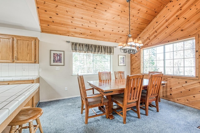 42153 Hemlock Ln, Shaver Lake, CA 93664 - dining space featuring light carpet, a chandelier, vaulted ceiling, wood ceiling, and wooden walls