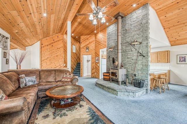 42153 Hemlock Ln, Shaver Lake, CA 93664 - carpeted living area with a wood stove, wooden ceiling, a ceiling fan, high vaulted ceiling, and stairs