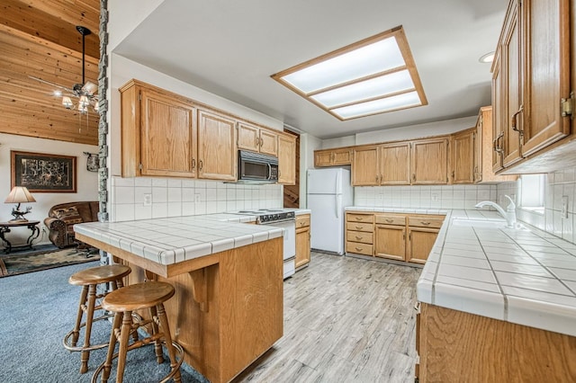 42153 Hemlock Ln, Shaver Lake, CA 93664 - kitchen with white appliances, tile countertops, tasteful backsplash, and a peninsula