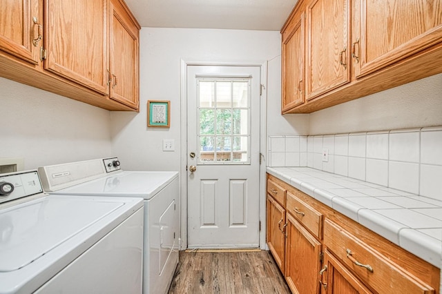 42153 Hemlock Ln, Shaver Lake, CA 93664 - washroom with separate washer and dryer, cabinet space, and wood finished floors