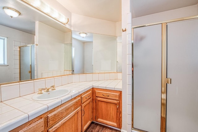 42153 Hemlock Ln, Shaver Lake, CA 93664 - full bath featuring a shower stall, vanity, and wood finished floors