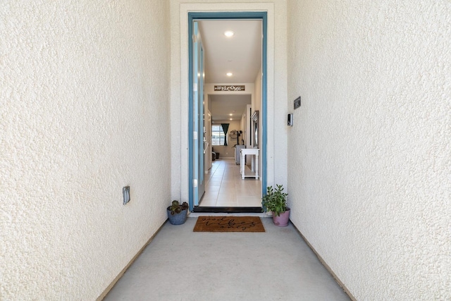 entrance to property featuring stucco siding