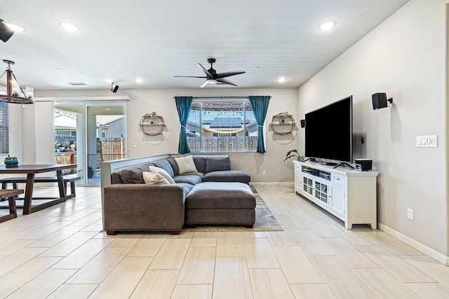 living room with baseboards, a ceiling fan, visible vents, and recessed lighting