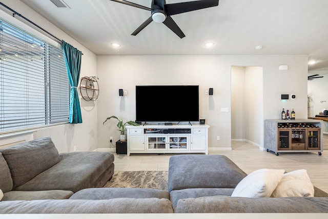 living room with baseboards, recessed lighting, and ceiling fan