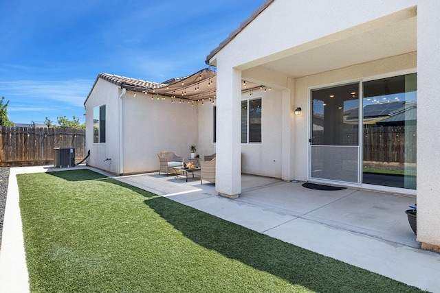 back of property featuring central AC, fence, a yard, a patio, and stucco siding