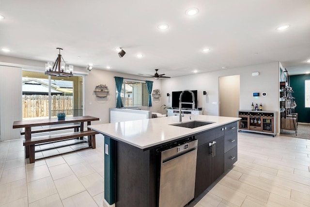kitchen featuring recessed lighting, light countertops, a sink, a kitchen island with sink, and open floor plan