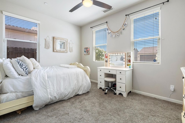 carpeted bedroom with ceiling fan, baseboards, and visible vents