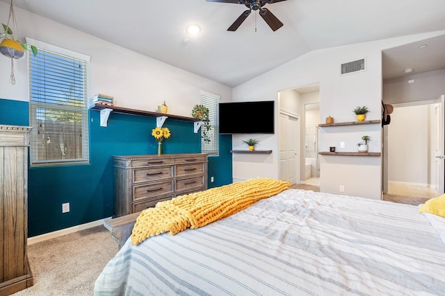 carpeted bedroom featuring vaulted ceiling, a ceiling fan, ensuite bathroom, baseboards, and visible vents