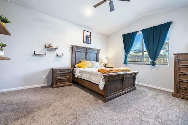 carpeted bedroom featuring vaulted ceiling, baseboards, and a ceiling fan
