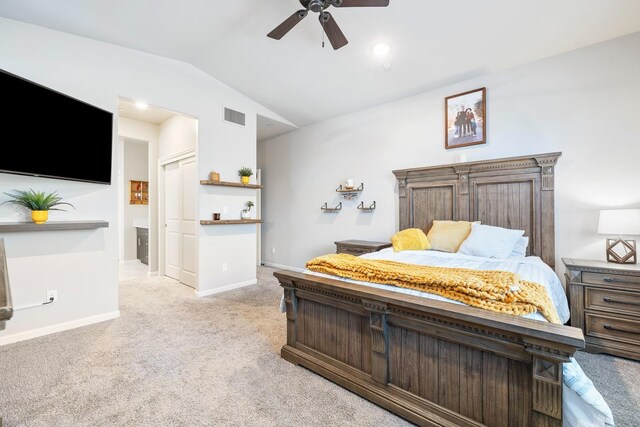 bedroom featuring light carpet, baseboards, visible vents, lofted ceiling, and ceiling fan