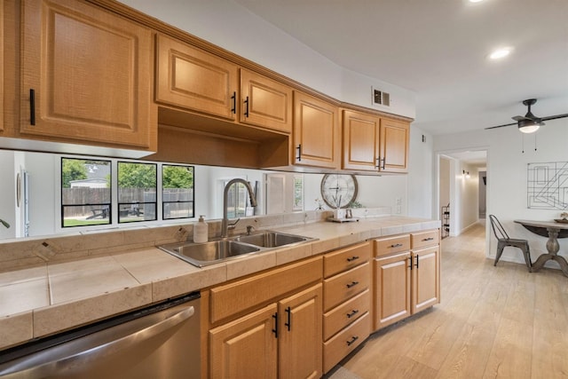 kitchen with recessed lighting, dishwasher, visible vents, tile countertops, and a sink