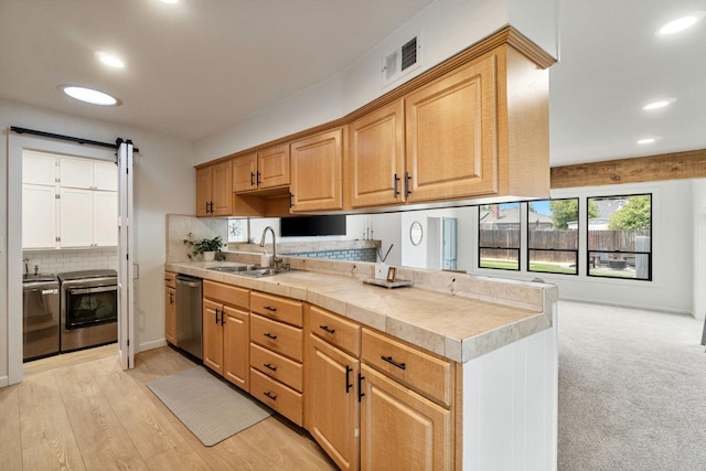340 W Escalon Ave, Fresno, CA 93704 - kitchen with washer and dryer, stainless steel dishwasher, tasteful backsplash, recessed lighting, and a peninsula