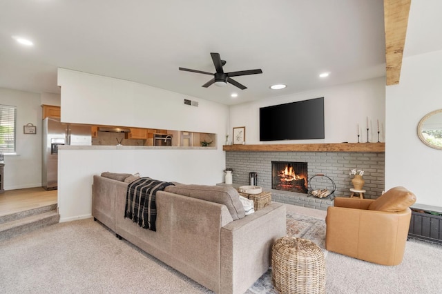 living room featuring recessed lighting, visible vents, a fireplace, light colored carpet, and ceiling fan