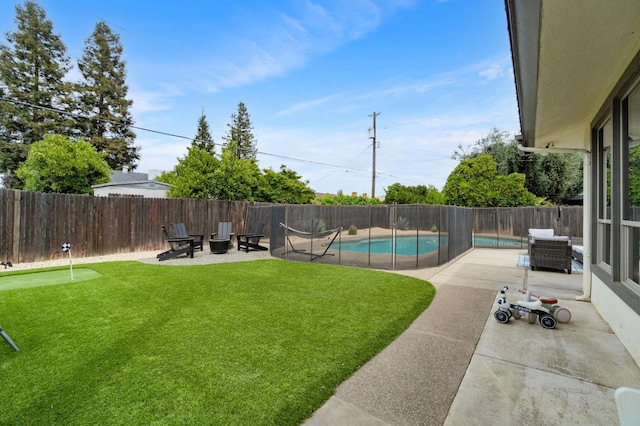 view of yard featuring a fenced in pool, a patio, and a fenced backyard
