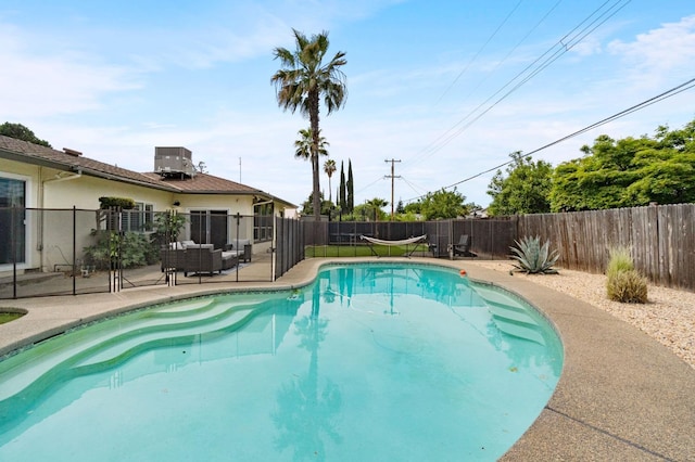 view of swimming pool featuring a fenced backyard, central air condition unit, a patio area, and a fenced in pool