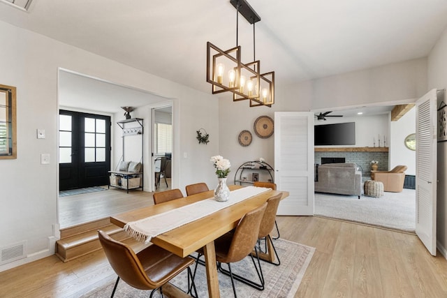 340 W Escalon Ave, Fresno, CA 93704 - dining space with a brick fireplace, light wood finished floors, ceiling fan, and a chandelier