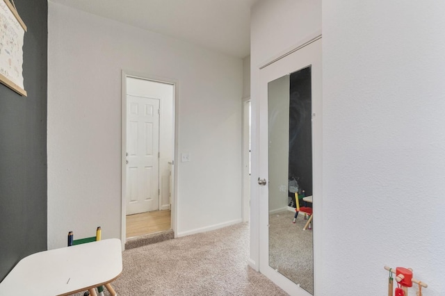 interior space featuring carpet and baseboards