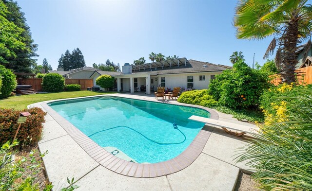 view of pool featuring a fenced in pool, a lawn, a patio, and fence