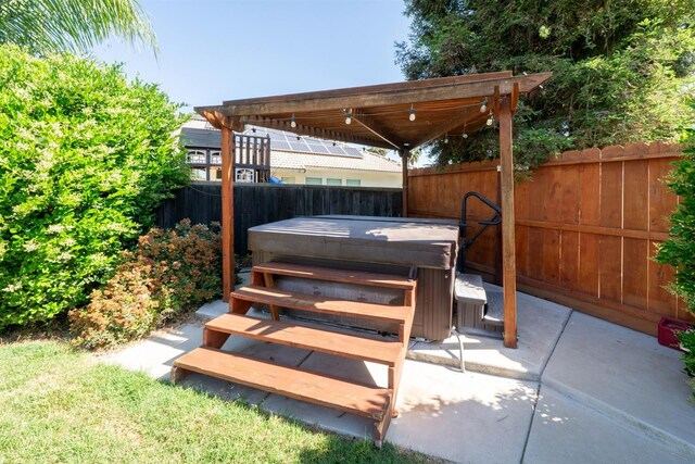 wooden deck featuring a fenced backyard, a hot tub, and a patio area