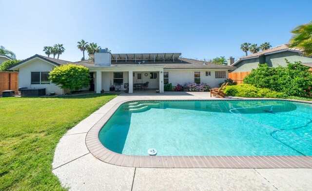 view of swimming pool with fence, a patio area, a lawn, and a fenced in pool