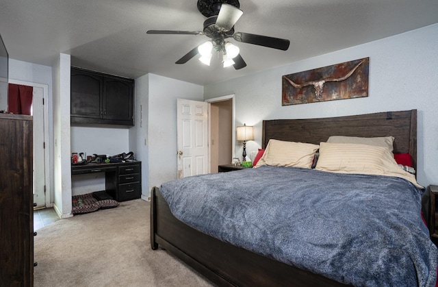 bedroom featuring ceiling fan, light carpet, and baseboards