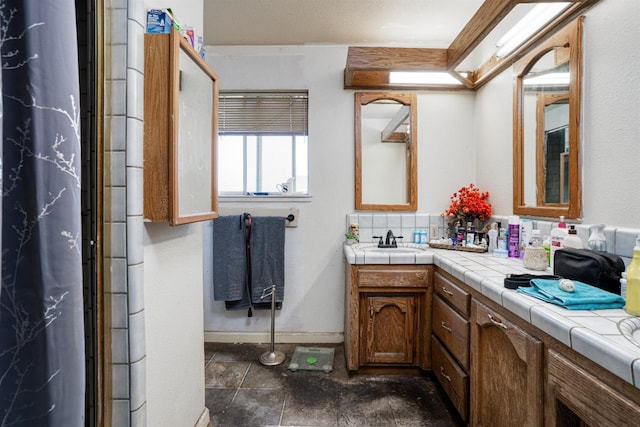 full bathroom with baseboards and vanity