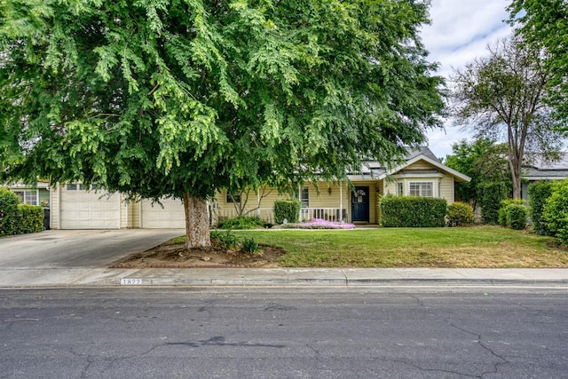 obstructed view of property with concrete driveway, a porch, and a front yard