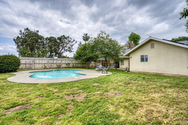 view of pool with a fenced backyard, a patio, a fenced in pool, and a lawn