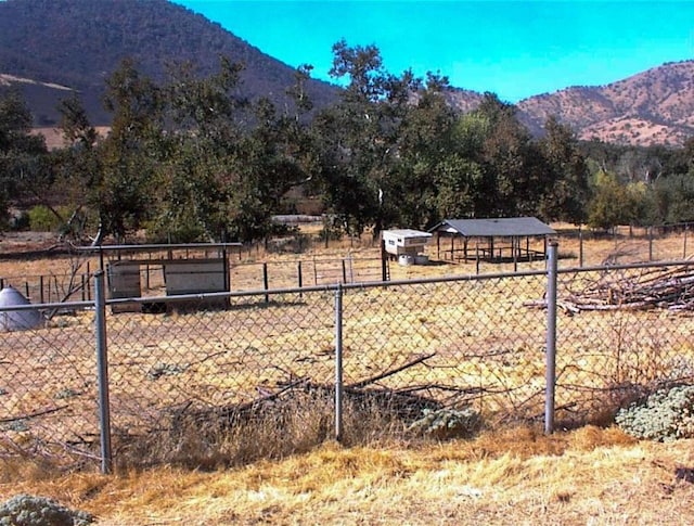 7081 Live Oak, Wonder Valley, CA 93657 - view of yard featuring fence, a rural view, and a mountain view