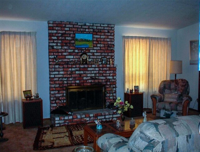7081 Live Oak, Wonder Valley, CA 93657 - living room with a fireplace, carpet flooring, and a wealth of natural light