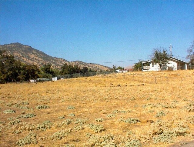 7081 Live Oak, Wonder Valley, CA 93657 - view of yard featuring a rural view, fence, and a mountain view