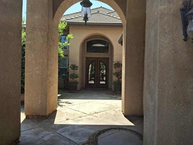 view of exterior entry with stucco siding and french doors