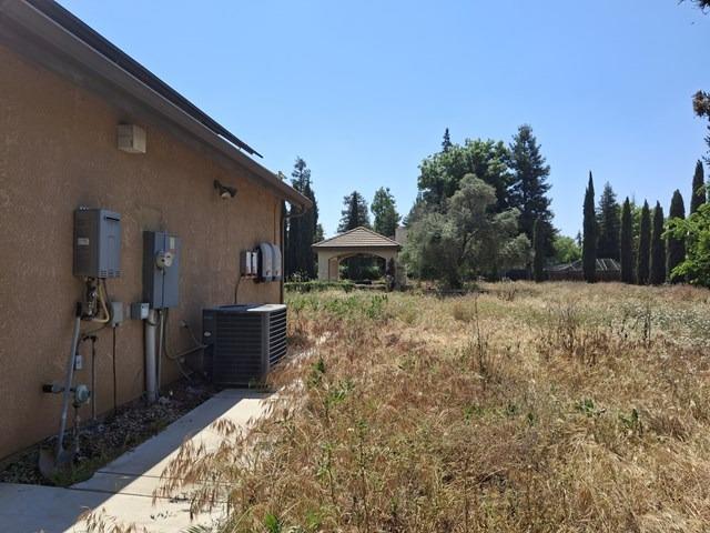 view of yard featuring a gazebo and central AC unit