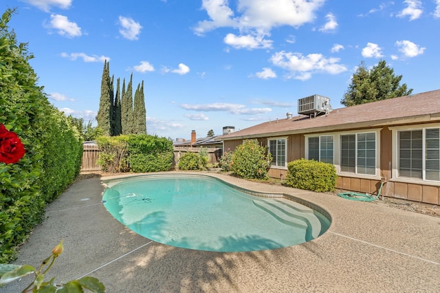 view of pool with a patio area, a fenced backyard, a fenced in pool, and central AC