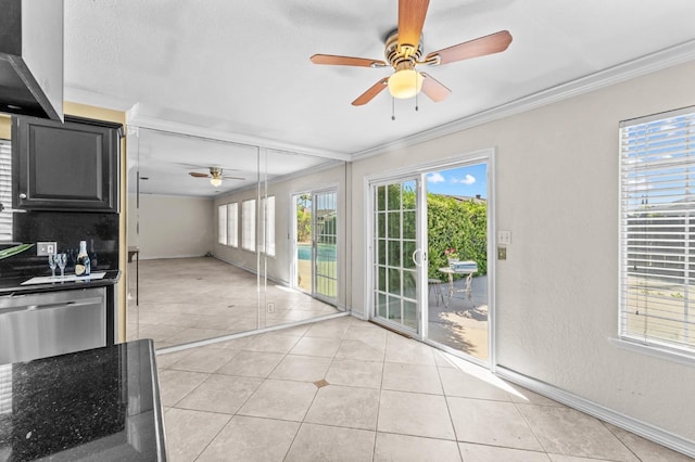 interior space featuring crown molding, baseboards, and tile patterned floors