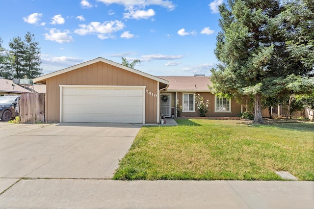 ranch-style house with fence, driveway, a front lawn, and a garage