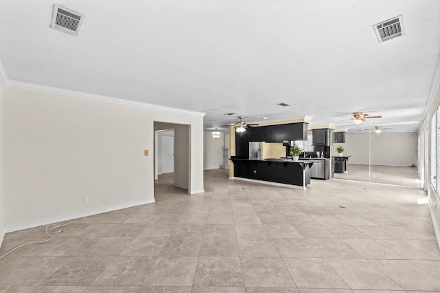 unfurnished living room with ceiling fan, ornamental molding, and visible vents