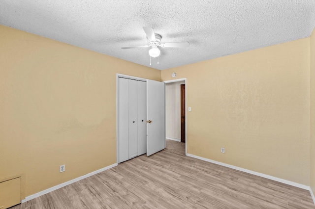 unfurnished bedroom with a closet, light wood finished floors, and baseboards
