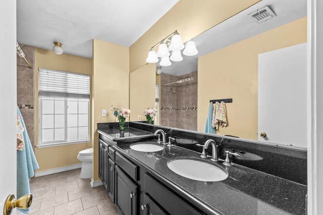 bathroom with tile patterned flooring, visible vents, toilet, and a sink