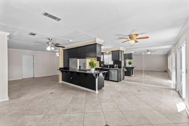 kitchen with a ceiling fan, visible vents, and ornamental molding