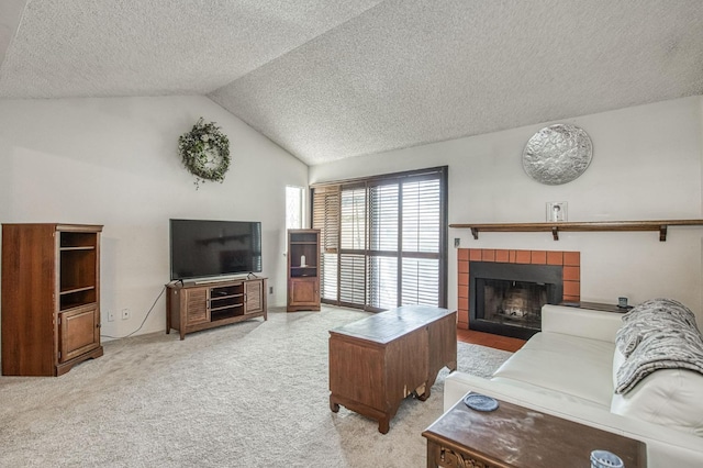 living room with lofted ceiling, carpet, a tiled fireplace, and a textured ceiling