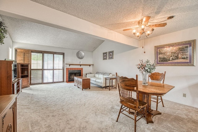 carpeted dining space featuring a brick fireplace, lofted ceiling, a textured ceiling, and ceiling fan