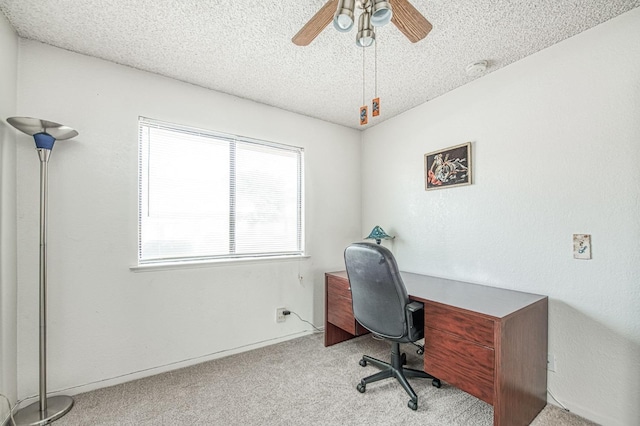 office space with ceiling fan, a textured ceiling, and carpet