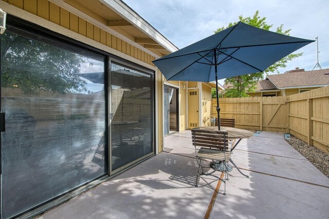 view of patio / terrace featuring fence and a gate