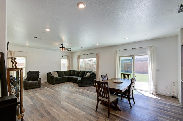 dining space with baseboards, a ceiling fan, wood finished floors, and recessed lighting